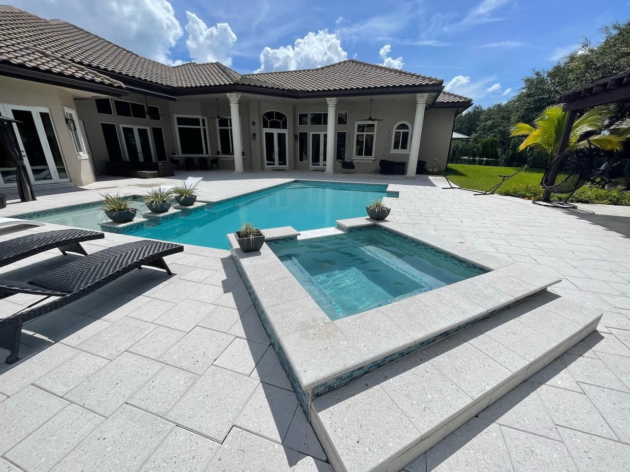 Modern pool with spa and paver deck at a South Florida home