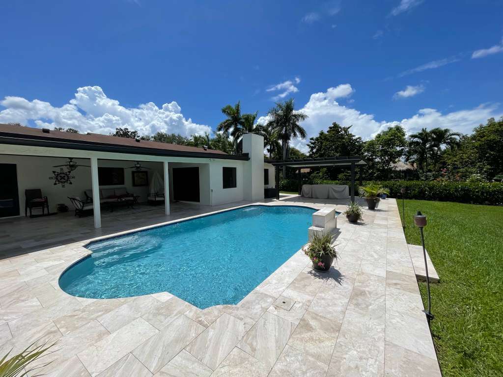 Pool renovation with travertine deck pavers and modern coping